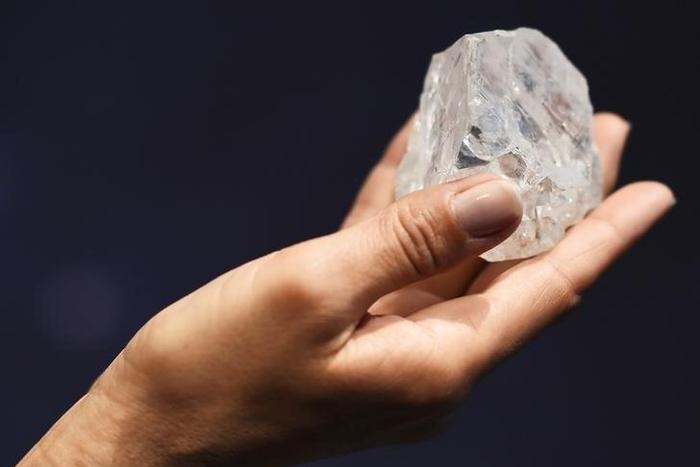 A model shows off the 1109 carat "Lesedi La Rona", the largest gem quality rough diamond discovered in over 100 years during a sale preview at Sotheby's auction house in London, Britain, June 14, 2016. REUTERS/Dylan Martinez