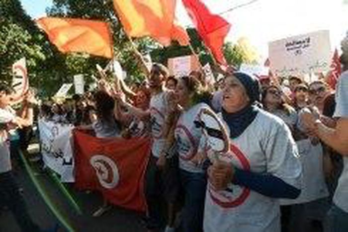 Tunisians demonstrate against a bill being discussed in parliament to grant amnesty to people accused of corruption on July 25, 2016