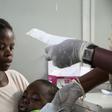 A mother holds her son suffering from yellow fever as she waits for a prescription at a hospital in Luanda?, Angola, March 15, 2016.