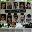 A poster showing cabin crew from missing Malaysia Airlines flight MH370 is displayed during a prayer at a school in Petaling Jaya 