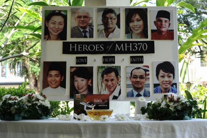 A poster showing cabin crew from missing Malaysia Airlines flight MH370 is displayed during a prayer at a school in Petaling Jaya 