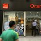 People walk past a new shop of French telecom operator Orange, which was previously known as Mobinil, in Cairo, Egypt, April 6, 2016. REUTERS/Amr Abdallah Dalsh