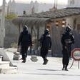 Tunisian police officers stand guard near a police station in the town of Ben Guerdan, Tunisia, near the Libyan border March 8, 2016.