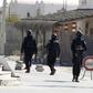 Tunisian police officers stand guard near a police station in the town of Ben Guerdan, Tunisia, near the Libyan border March 8, 2016.
