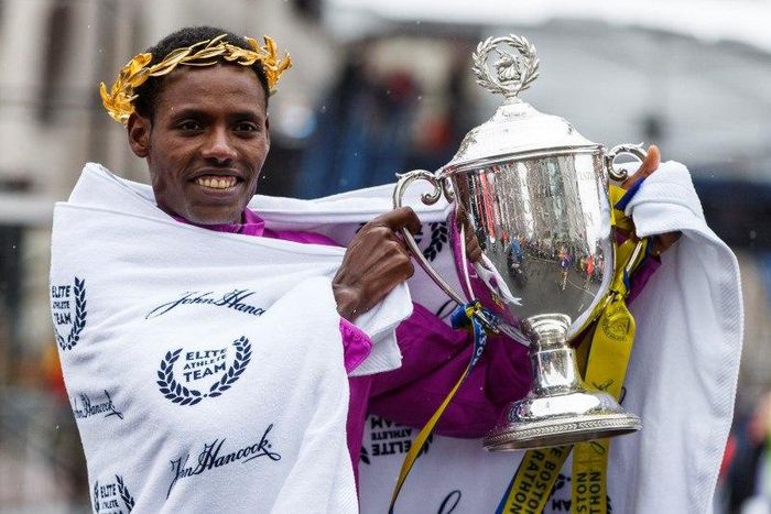 Lelisa Desisa of Ethiopia holds up the trophy after winning the 119th Boston Marathon.