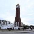 People sit in front of the clock tower at the end of Avenue Habib Bourguiba in Tunis, Tunisia, February 13, 2016.