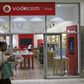 A shopper walks past a Vodacom shop in Johannesburg February 4, 2015.