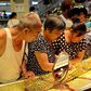Customers look at gold necklaces at a jewelry store in Xuchang, Henan province, August 12, 2015.