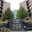 A worker sweeps in front of the Johannesburg Stock Exchange (JSE), in this picture taken March 23, 2016. Picture taken March 23, 2016.