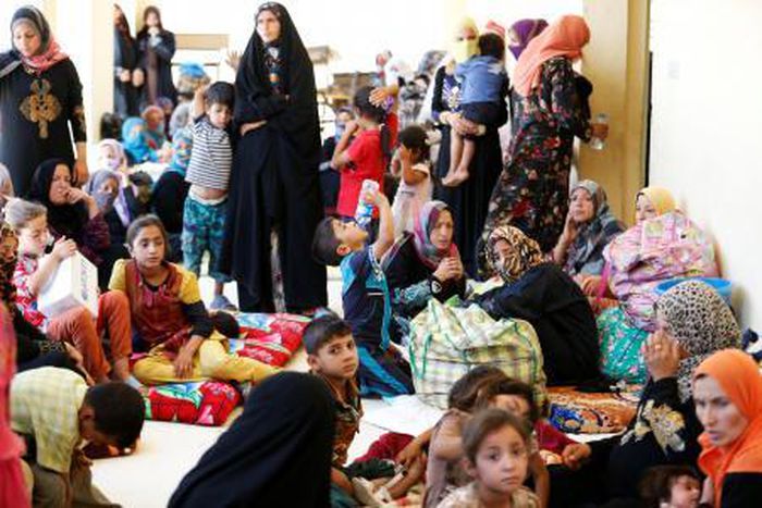 Civilians who fled their homes due to clashes on the outskirts of Falluja, gather in the town of Garma, Iraq.