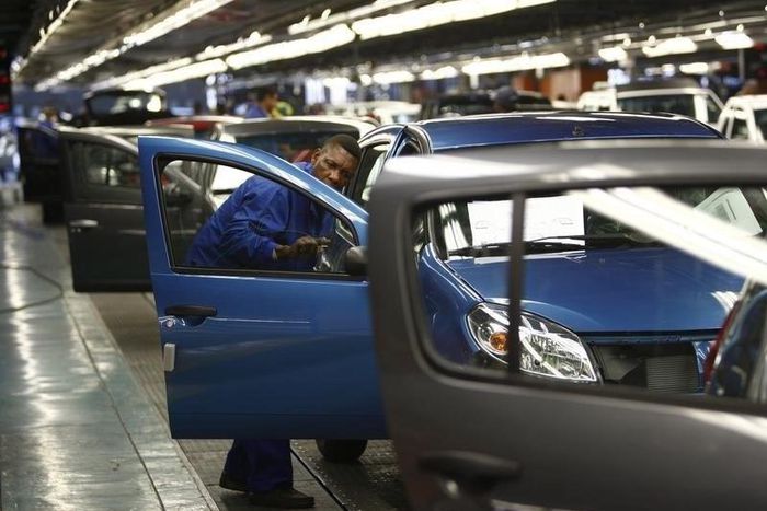 A worker inspects cars at Nissan's manufacturing plant in Rosslyn, outside Pretoria, file.