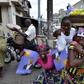 Street vendors hold campaign posters for presidential candidate Patrice Talon ahead of the second round of Benin's presidential election on Sunday in Cotonou, Benin, March 18, 2016. REUTERS/Charles Placide Tossou