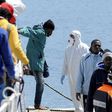Migrants disembark from a Coast Guard boat as they arrive in the Sicilian harbour of Palermo, April 15, 2015.   REUTERS/Guglielmo Mangiapane