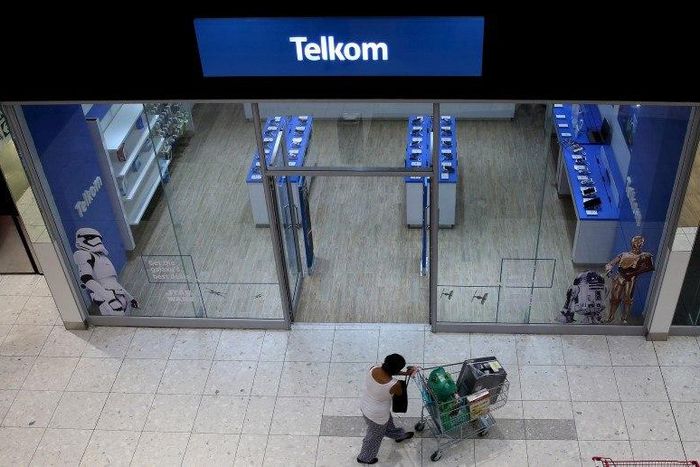 A shopper walks past a Telkom shop at a mall in Johannesburg February 26, 2016.