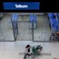 A shopper walks past a Telkom shop at a mall in Johannesburg February 26, 2016.