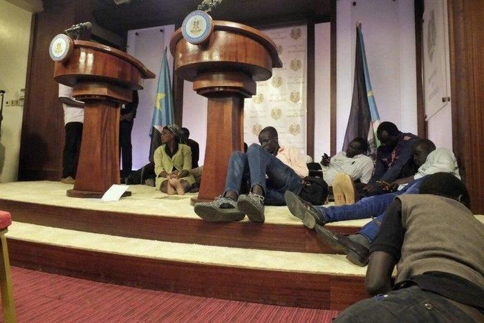 Journalists are seen on the podium following sounds of gun shots before a news conference inside the Presidential State House in Juba, South Sudan, July 8, 2016. REUTERS/Stringer
