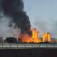 A fire next to the Libyan cement factory is seen during clashes between military forces loyal to Libya's eastern government, who are backed by the locals, and the Shura Council of Libyan Revolutionaries, an alliance of former anti-Gaddafi rebels, who h...