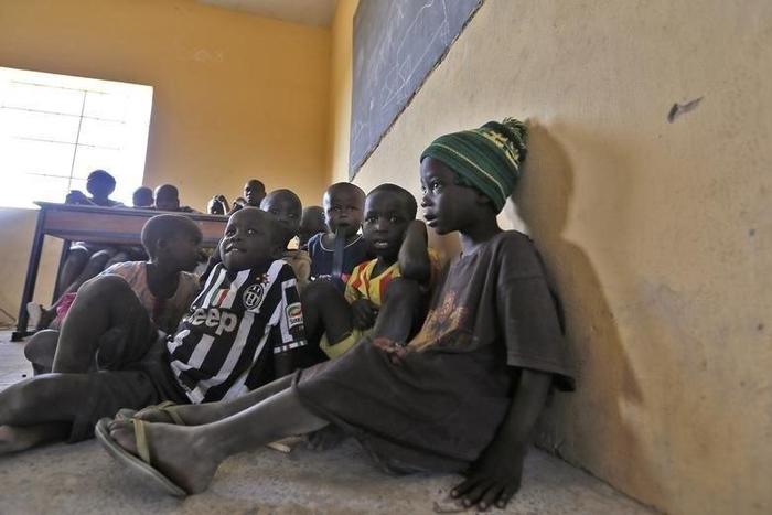 Children displaced as a result of Boko Haram attack in the northeast region of Nigeria, attend a class at Maikohi secondary school camp for internally displaced persons (IDP) in Yola, Adamawa State January 13, 2015.
