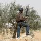 A Tunisian police officer stands guard during an operation to eliminate militants in a village some 50 km (31 miles) from the town of Ben Guerdane, Tunisia, near the Libyan border, March 10, 2016. REUTERS/Zoubeir Souissi