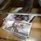 A teller serves a client with Kenya shilling notes at the cashier's booth of a forex exchange bureau in Kenya's capital Nairobi, April 20, 2016. REUTERS/Thomas Mukoya
