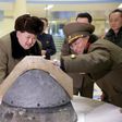 North Korean leader Kim Jong Un looks at a rocket warhead tip after a simulated test of atmospheric re-entry of a ballistic missile, at an unidentified location in this undated file photo released by North Korea"s Korean Central News Agency (KCNA) in P...