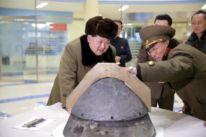 North Korean leader Kim Jong Un looks at a rocket warhead tip after a simulated test of atmospheric re-entry of a ballistic missile, at an unidentified location in this undated file photo released by North Korea"s Korean Central News Agency (KCNA) in P...
