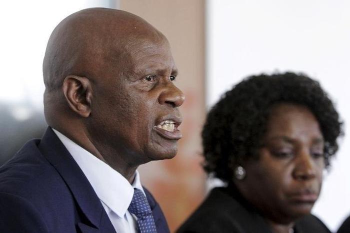 Zimbabwe's Finance Minister Patrick Chinamasa (L) addresses a media conference after meeting International Monetary Fund (IMF) Executive Director for Africa Chileshe Kapwepwe (R) in Harare, September 7, 2015.