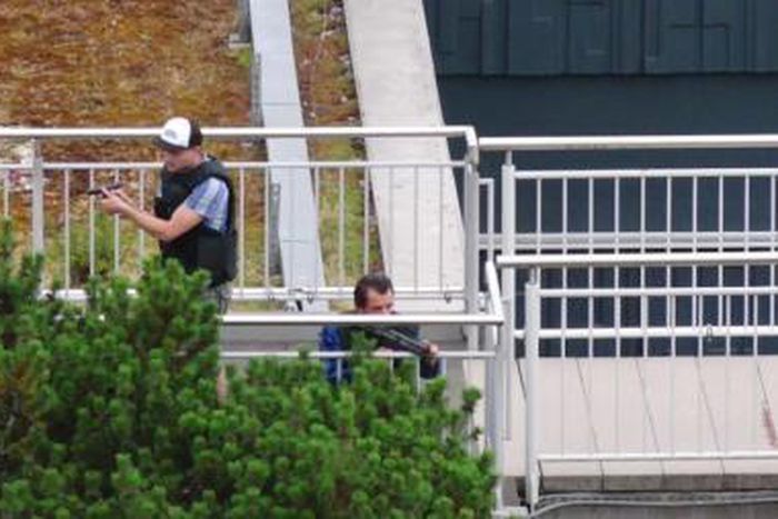 A screen grab taken from video footage shows plain clothes police officers at the scene of a shooting rampage at the Olympia shopping mall in Munich, Germany July 22, 2016.