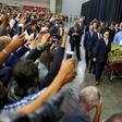 Worshipers and well-wishers take photographs as the casket with the body of the late boxing champion Muhammad Ali is brought for his jenazah, an Islamic funeral prayer, in Louisville, Kentucky, U.S. June 9, 2016.