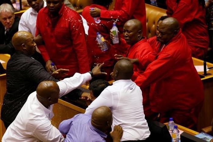 Party leader Julius Malema and members of his Economic Freedom Fighters (EFF) clash with Parliamentary security as they are evicted from the chamber in Cape Town, South Africa, May 17, 2016.