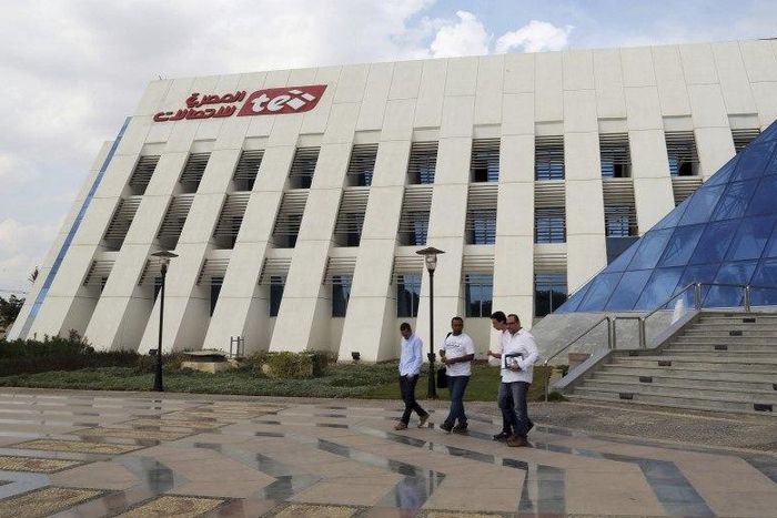 People leave the Telecom Egypt building at the Smart Village in the outskirts of Cairo, Egypt, October 27, 2015.