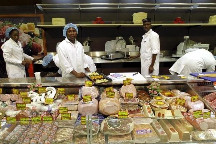 Workers arrange meat products inside the Nakumatt supermarket in the reopened Westgate shopping mall, in Kenya's capital Nairobi, July 18, 2015.     REUTERS/Thomas Mukoya