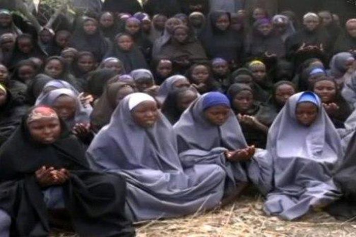 Kidnapped Chibok schoolgirls wearing the full-length hijab and praying at an undisclosed rural location.
