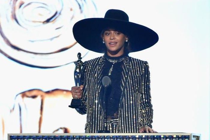 Beyonce receives the 2016 CFDA Fashion Icon Award in a shimmering Givenchy suit and hat