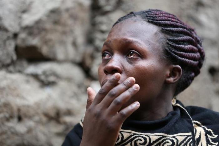 A woman reacts as rescue workers search for residents feared trapped in the rubble of a six-storey building that collapsed after days of heavy rain, in Nairobi, Kenya April 30, 2016.