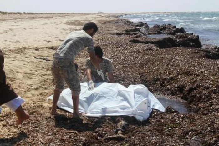 Guards place the body of a migrant into a body bag after a boat sank off the coastal town of Zuwara, west of Tripoli, Libya June 4, 2016.