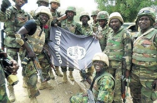 Nigerians soldiers destroy Boko Haram flag.
