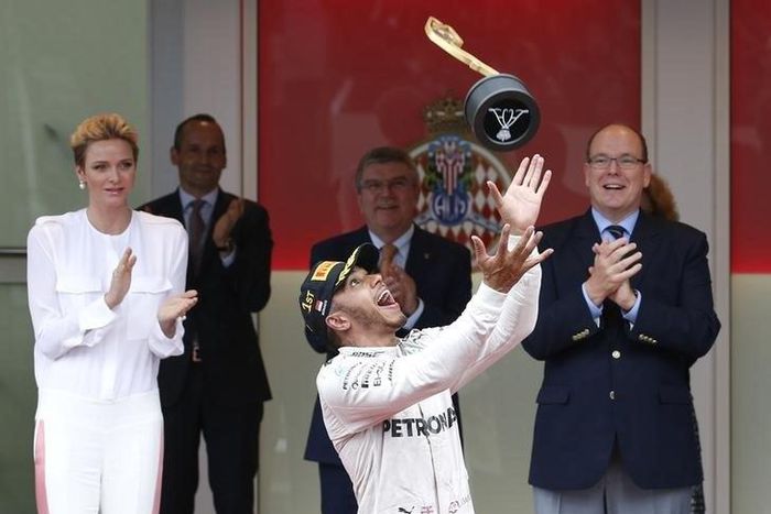 Formula One - Monaco Grand Prix - Monaco - 29/5/16. Mercedes F1 driver Lewis Hamilton celebrates after winning next to Prince Albert II of Monaco (R) and Princess Charlene.