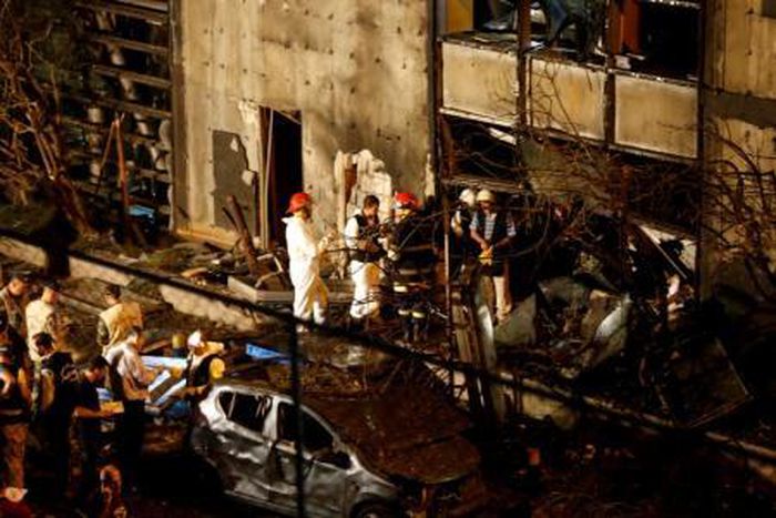 Forensic inspectors examine the site of an explosion at the headquarters of the Lebanese Blom Bank in Beirut, Lebanon June 12, 2016.