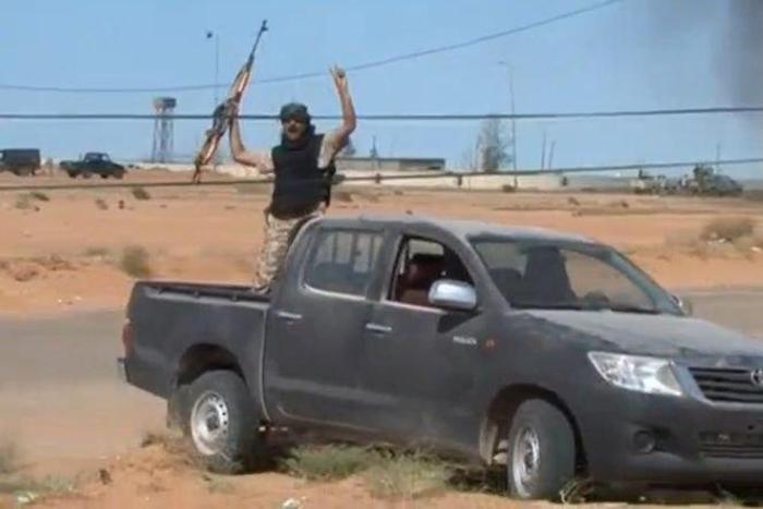 A still image from video released May 17, 2016 shows forces loyal to Libyan unity government celebrating the recapture of Abu Grain, one of the main checkpoints south of the city of Misrata, Libya from Islamic State.
