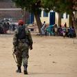 A soldier from the Sudan People's Liberation Movement (SPLM) walks within families displaced in recent fighting camping at the Anglican church compound in Juba, South Sudan, July 12, 2016.