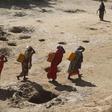 Women carry jerry cans of water from shallow wells dug from the sand along the Shabelle River bed, which is dry due to drought in Somalia's Shabelle region, March 19, 2016. REUTERS/Feisal Omar