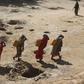Women carry jerry cans of water from shallow wells dug from the sand along the Shabelle River bed, which is dry due to drought in Somalia's Shabelle region, March 19, 2016. REUTERS/Feisal Omar