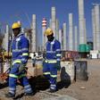 Workers are seen in front the construction site of Eskom's Medupi power station, a new dry-cooled coal fired power station, in Limpopo province, June 8, 2012.