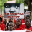 Bring Back Our Girls (BBOG) campaigners hold banners as they walk during a protest procession marking the 500th day since the abduction of girls in Chibok, along a road in Lagos August 27, 2015. REUTERS/Akintunde Akinleye