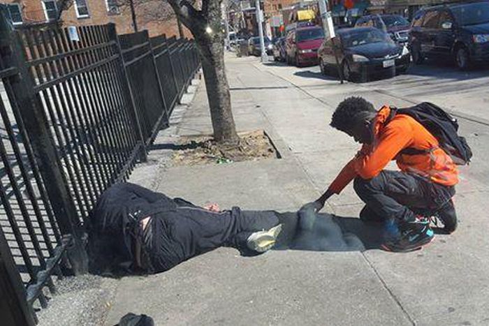 Baltimore teen stops to pray for homeless man