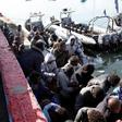 Migrants sit in a port, after being rescued at sea by Libyan coast guard, in Tripoli, Libya April 11, 2016.