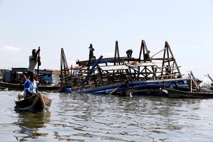 Residents work to dismantle the Makoko floating school after it collapsed in the Makoko fishing community on the Lagos lagoon, Nigeria June 8, 2016.