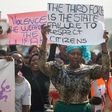 People sing political slogans and hold placards as they march through the streets of Bulawayo during a protest against police brutality, corruption and state of the economy on July 26, 2016 in Bulawayo 