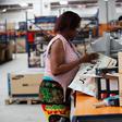 A woman works at the packaging unit at a warehouse for an online store, Jumia in Ikeja district, in Nigeria's commercial capital Lagos June 10, 2016.